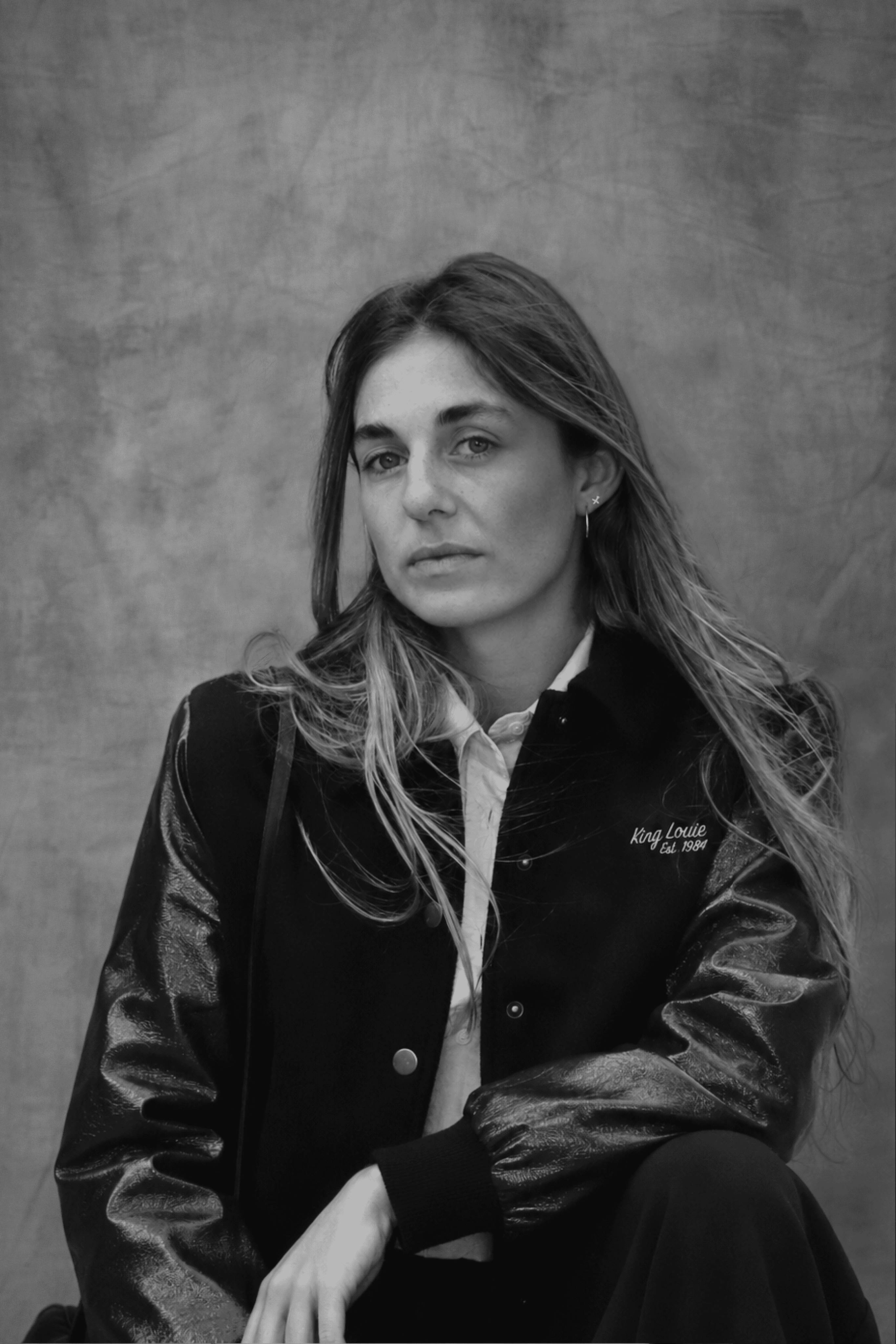 Black and white portrait of a team member in a black leather jacket