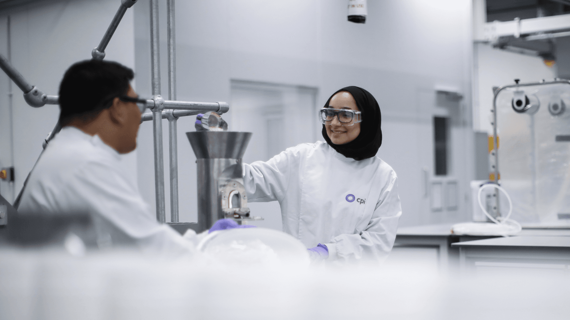 Two CPI scientist working at a CPI facility.