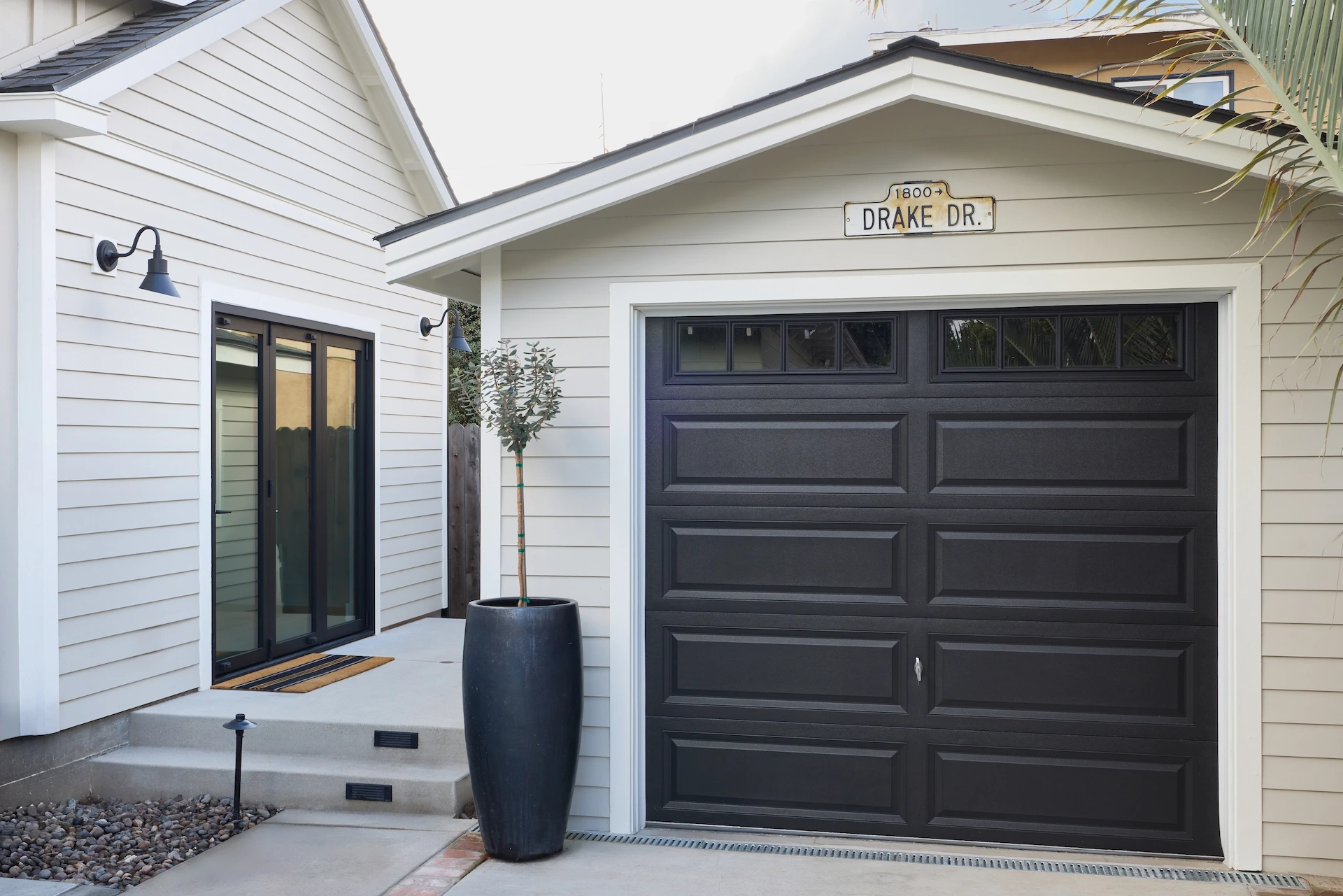 Wide view of the back porch and garage of ADU Orange, seamlessly integrating modern living with Craftsman-style architecture. Photo by Todd Huge.