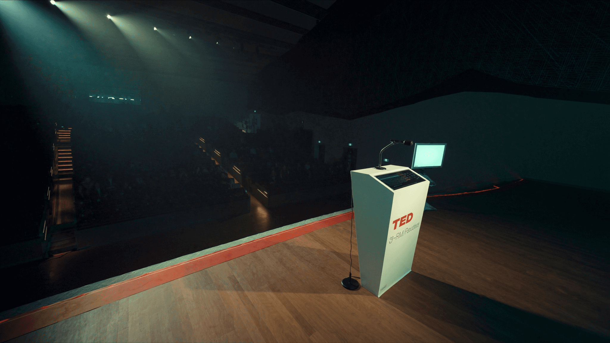Contemporary auditorium with dramatic stage lighting for presentations