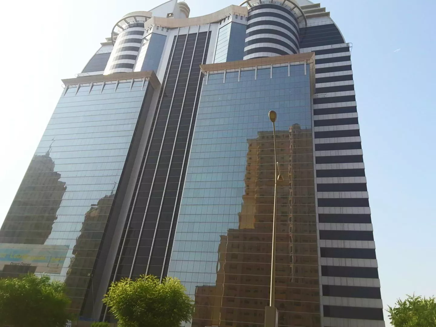 Close-up of the reflective glass panels on SIT Tower, ideal for professional corporate office listings.