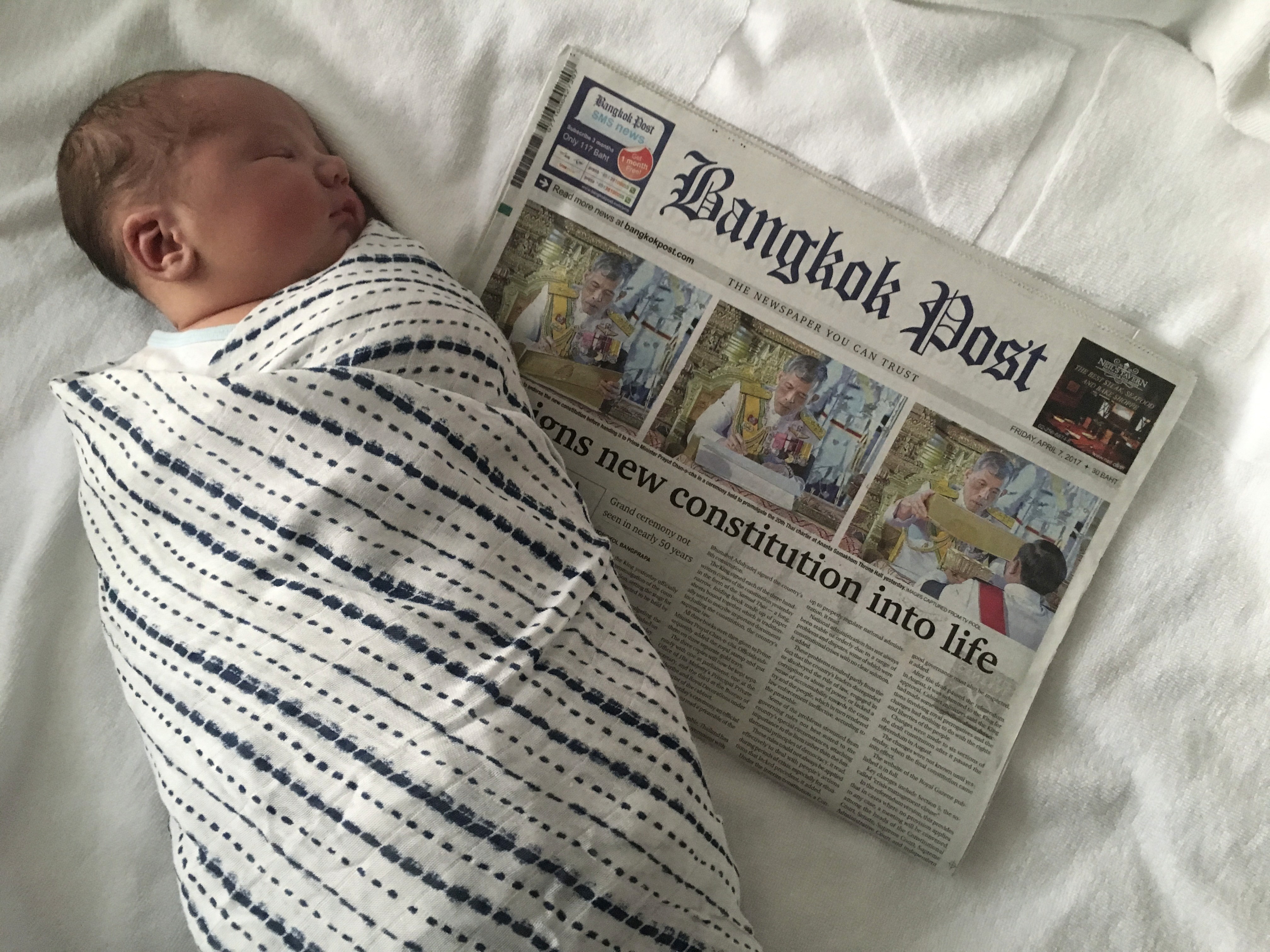 Lauren's baby next to Bangkok Post newspaper