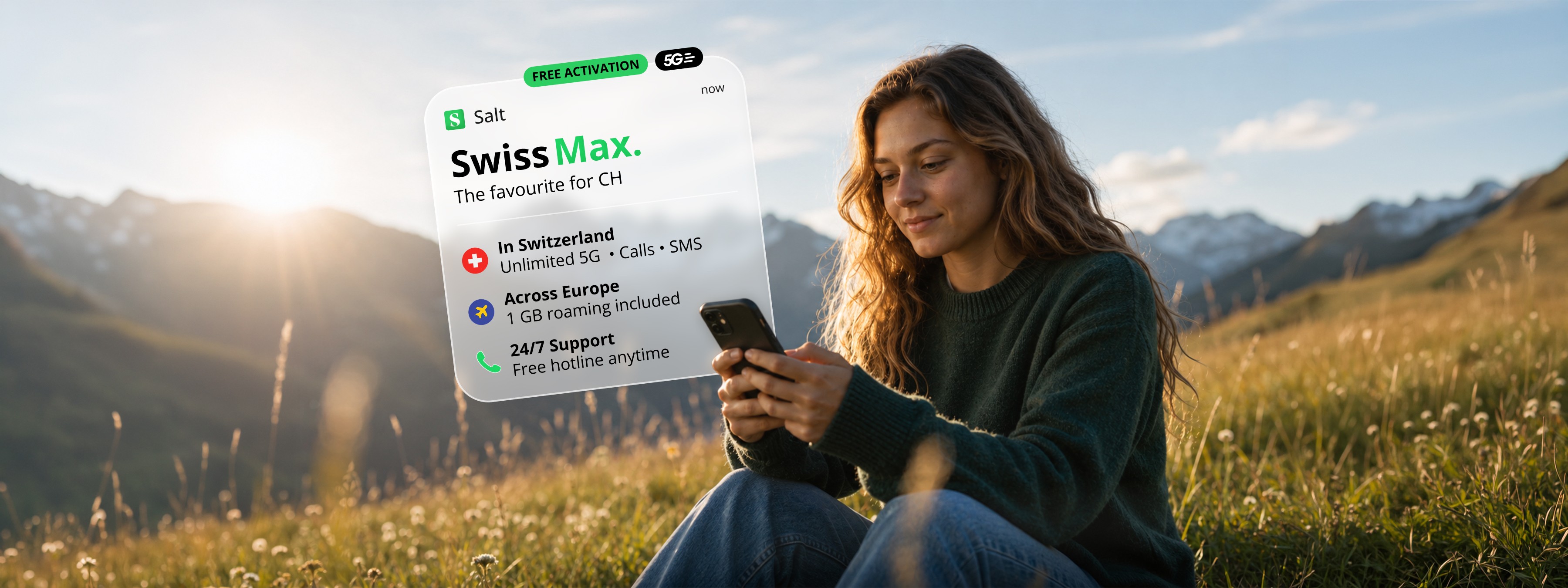 Young woman sitting in an Alpine meadow at golden hour, holding a smartphone. A translucent Salt Swiss Max card floats above her, showing the plan benefits. Salt Mobile rebrand concept, hero image.