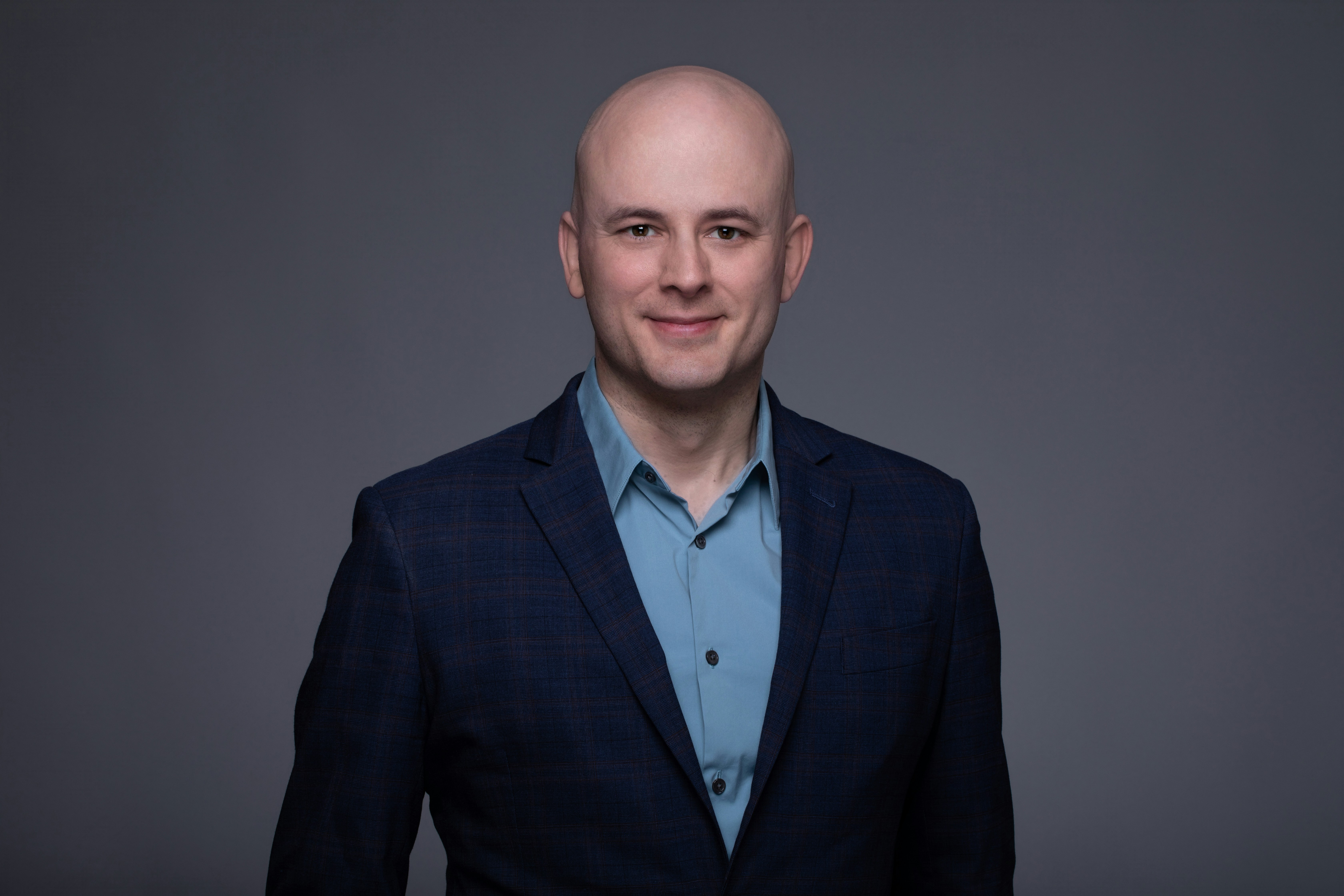 grayscale photography of man wearing black tuxedo