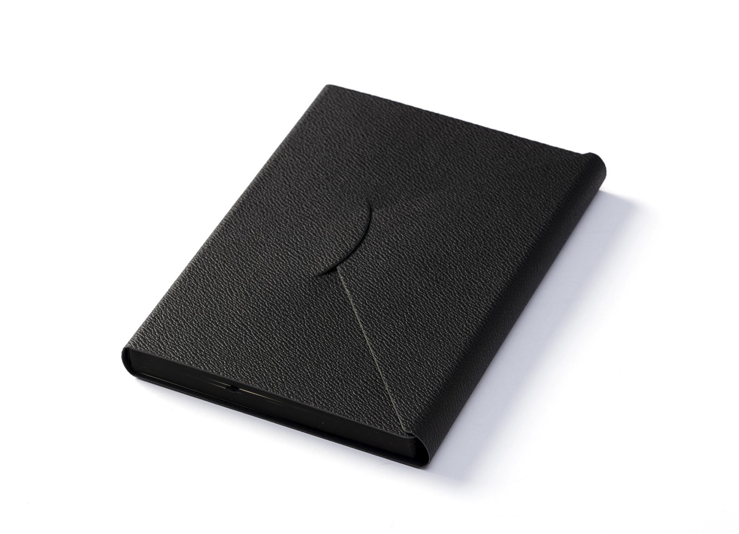 Angled view of closed black notebook with leather-like texture.