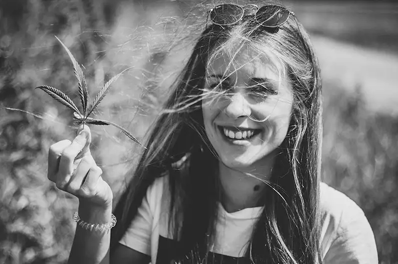 Women holds cannabis leaf