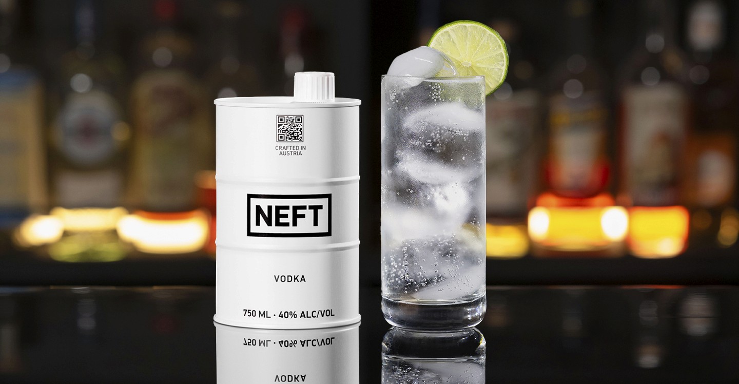 A NEFT Barrel and a glass of Vodka Soda on a bar counter.