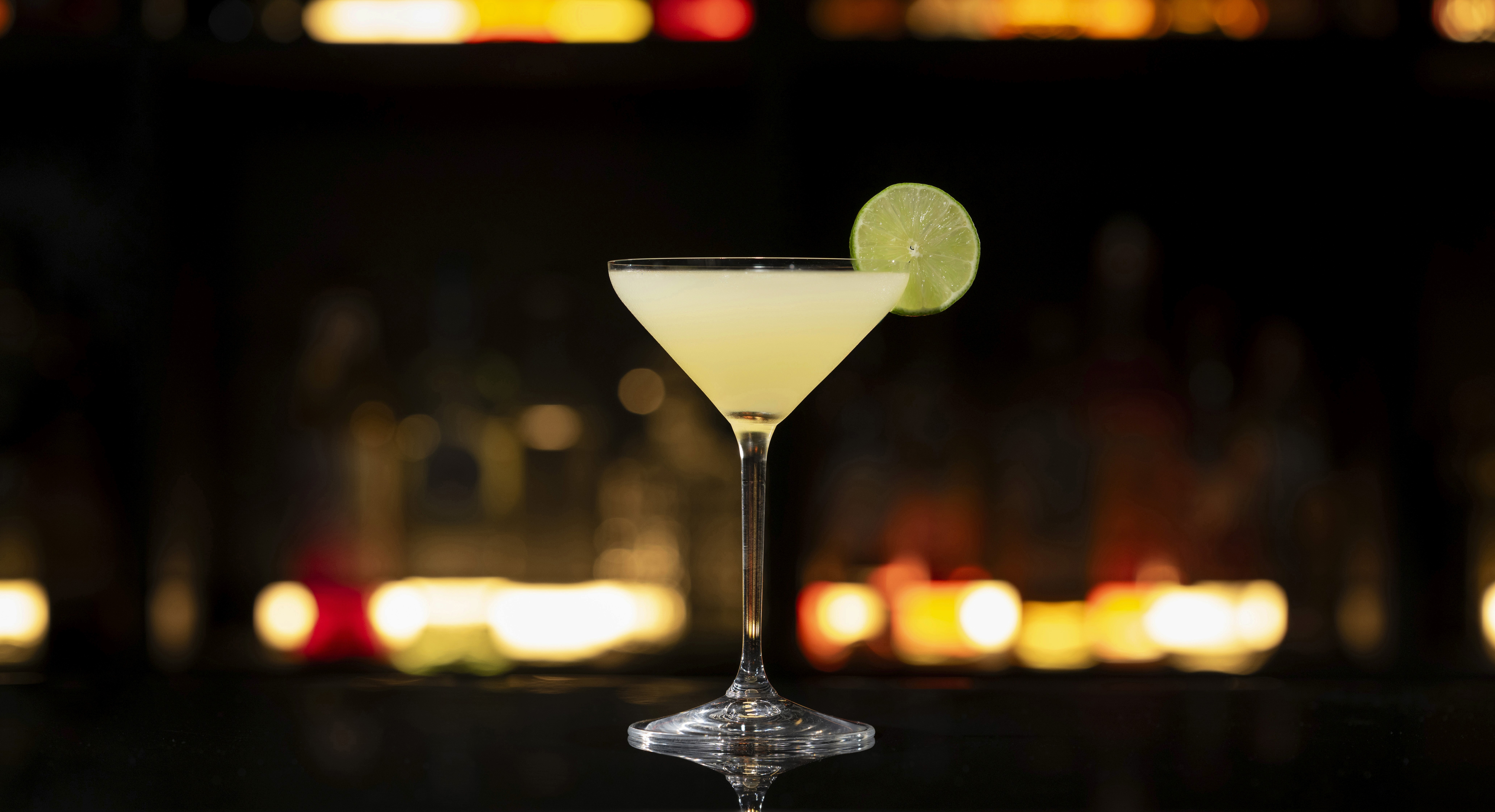 A NEFT Barrel and a glass of Kamikaze on a bar counter.