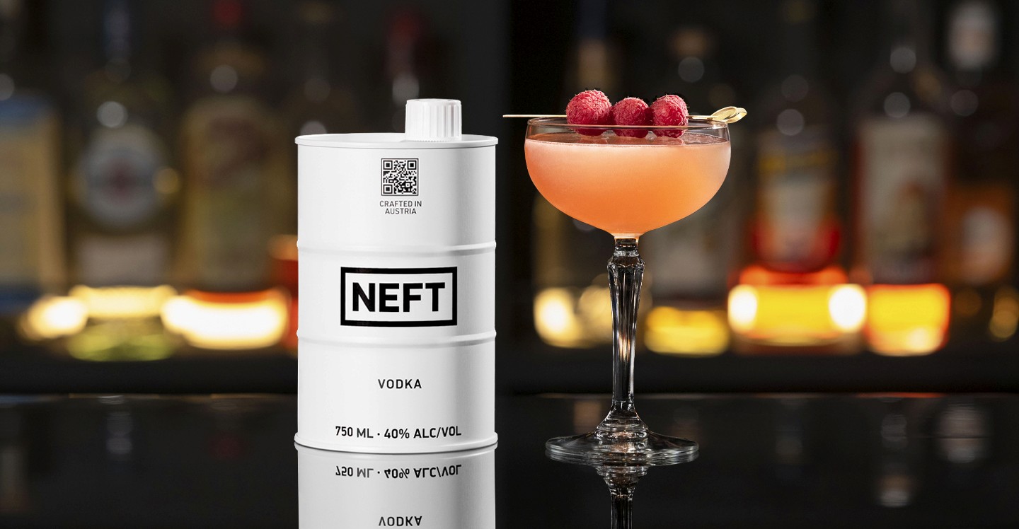 A NEFT Barrel and a glass of French Martini on a bar counter.