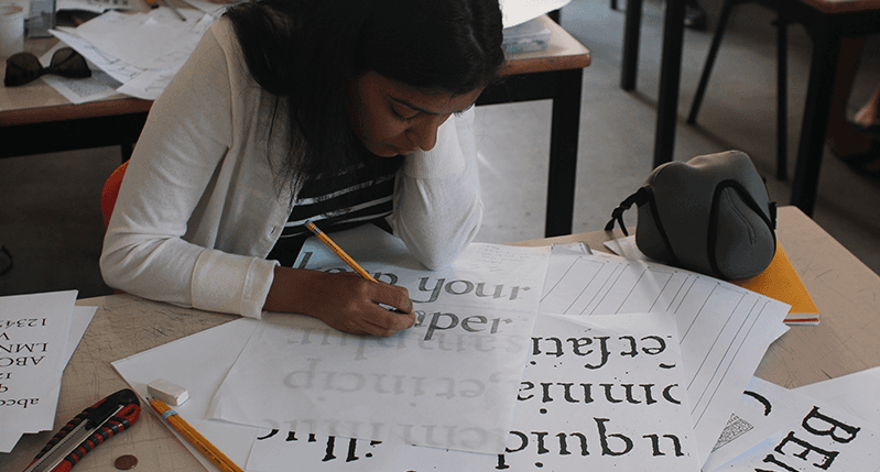 woman drawing type on type