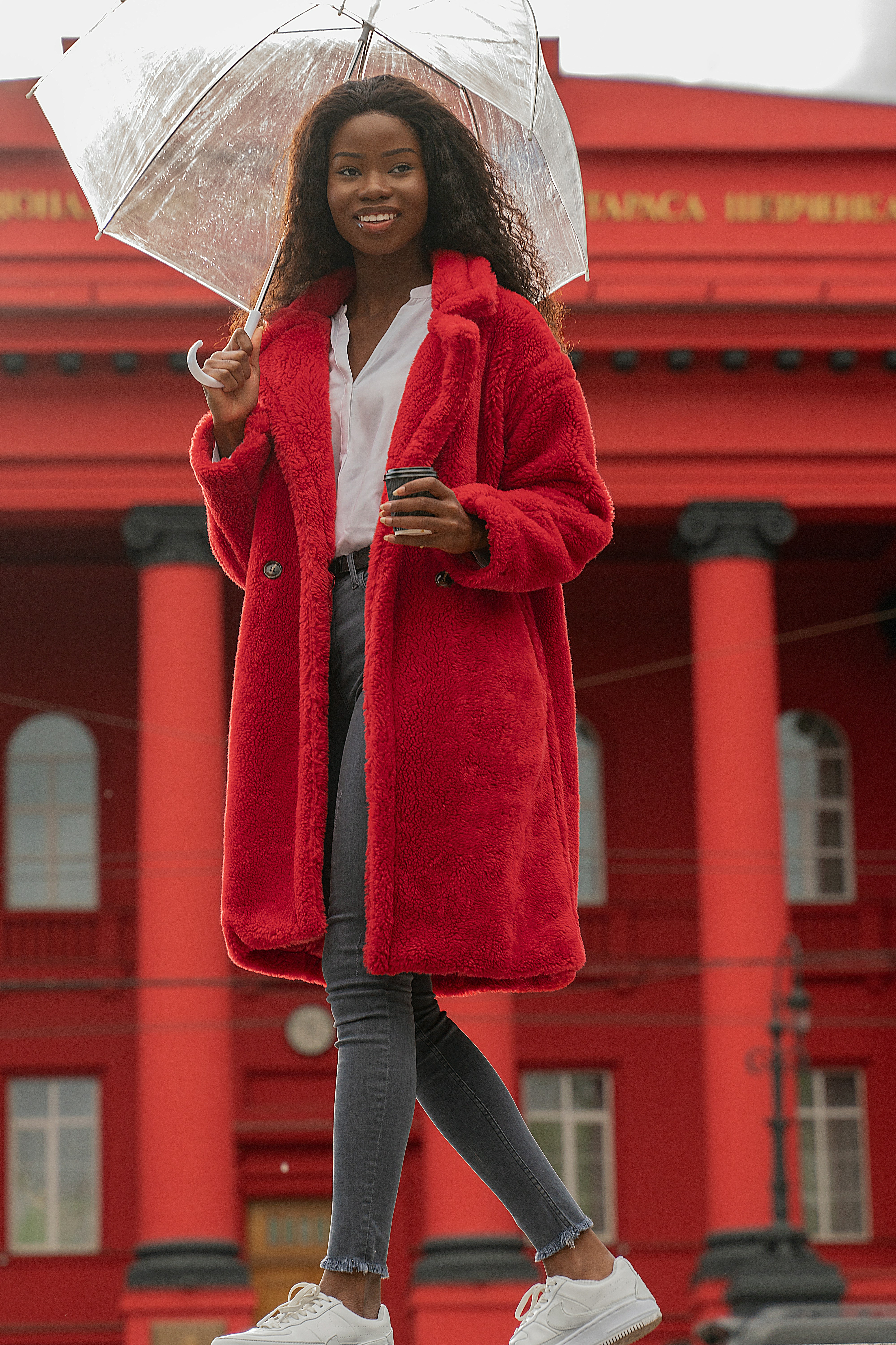 woman in gray coat and leopard scarf smiling