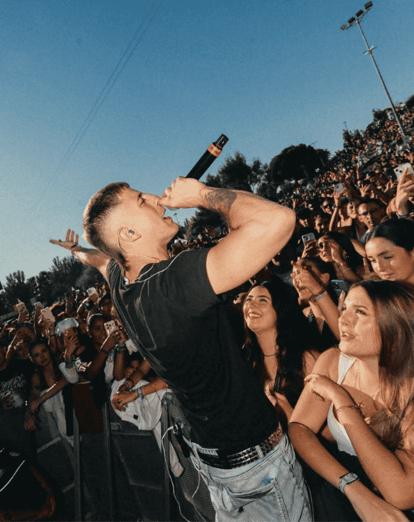 An artist performing on stage in front of a crowd