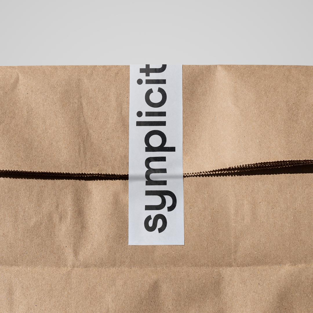 tipota design studio - symplicity kraft take away bag. Symplicity logo on tape to wrap product -  symplicity branding