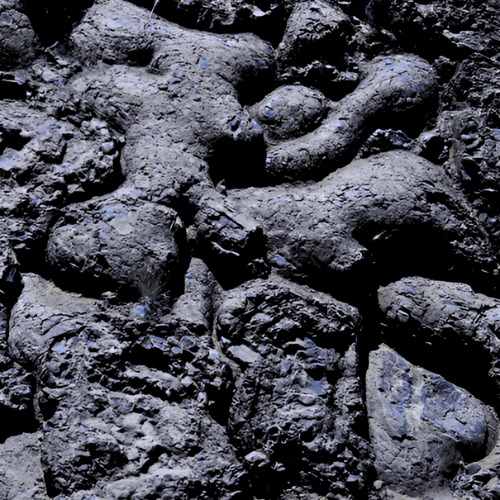 A smiling woman with her arms crossed, standing against a dark green background. She has long, dark hair.