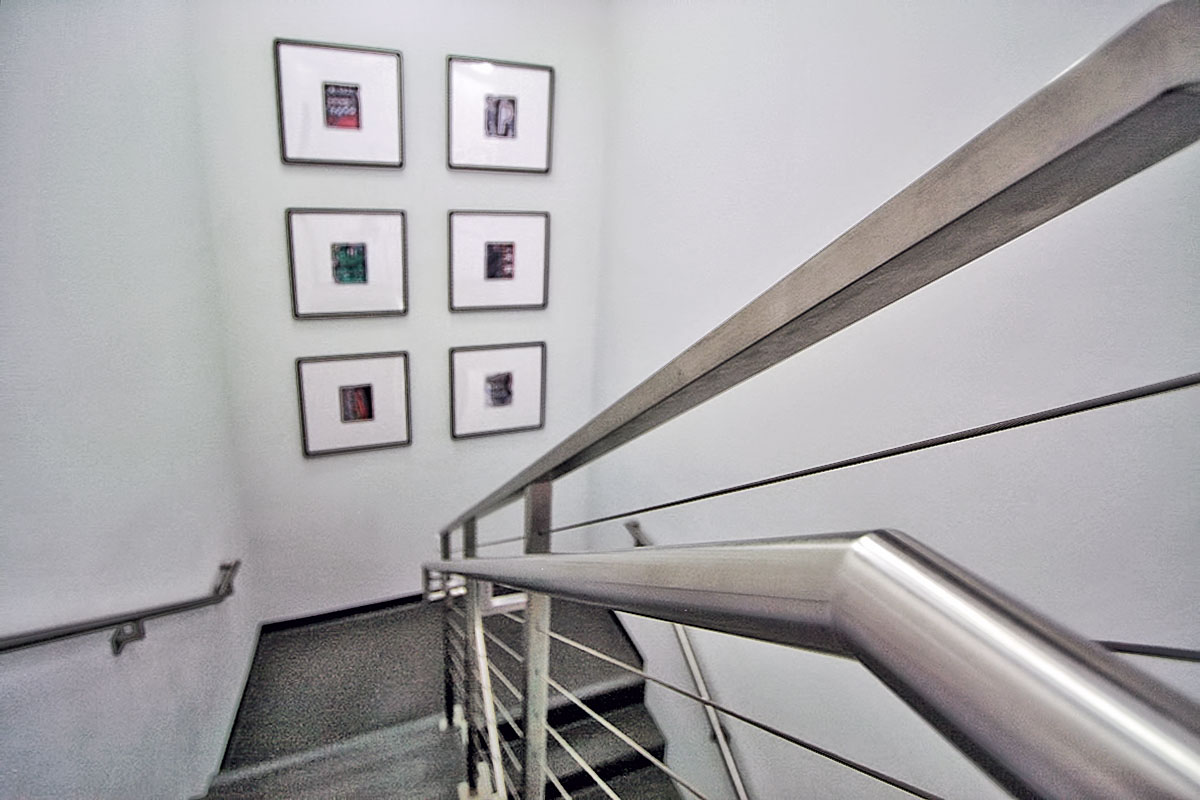 Steel wire staircase adding a sleek and industrial touch to the office space.