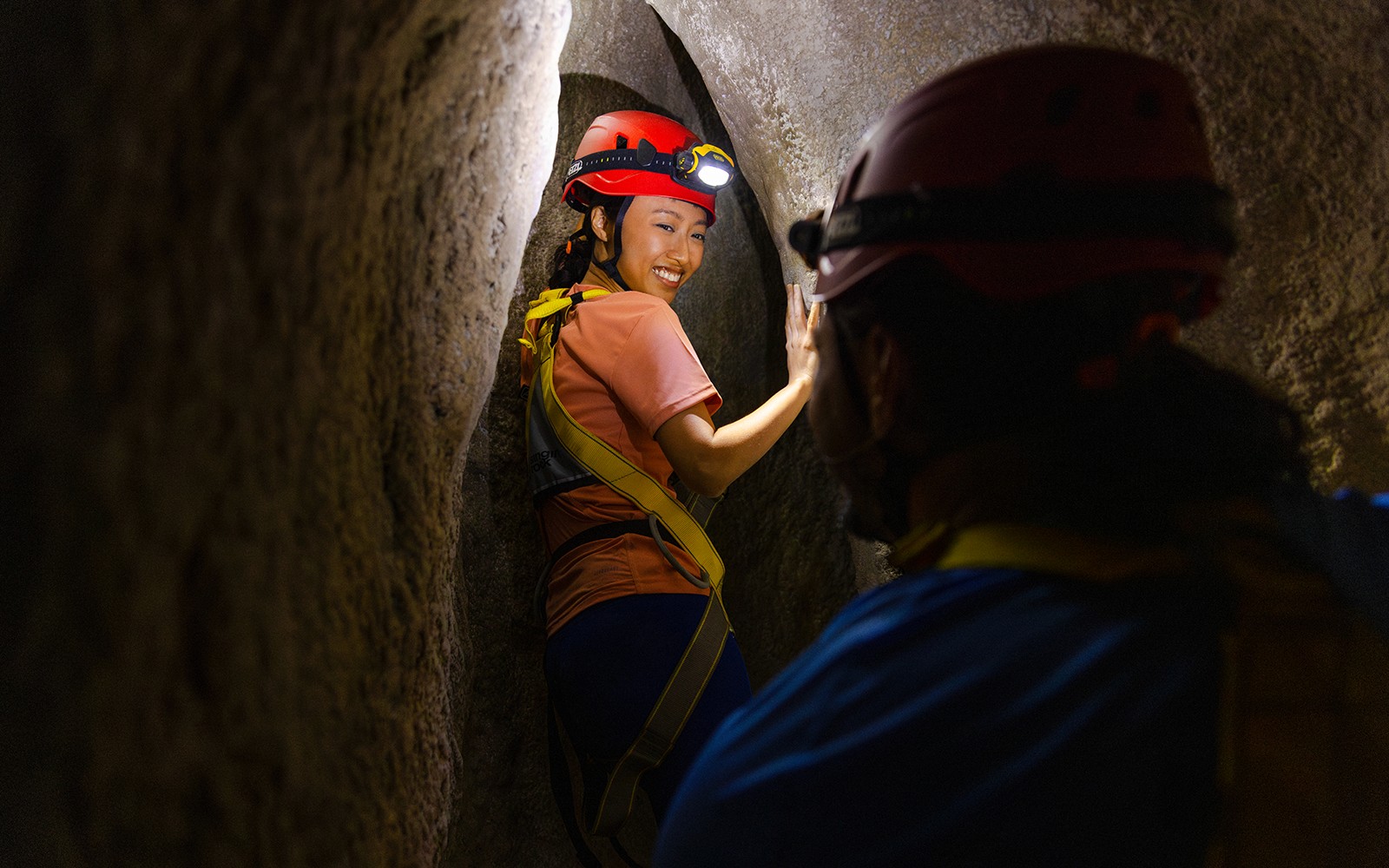 Visitors exploring Wild Cavern Adventure in Rainforest Wild ASIA, Singapore, surrounded by lush greenery.