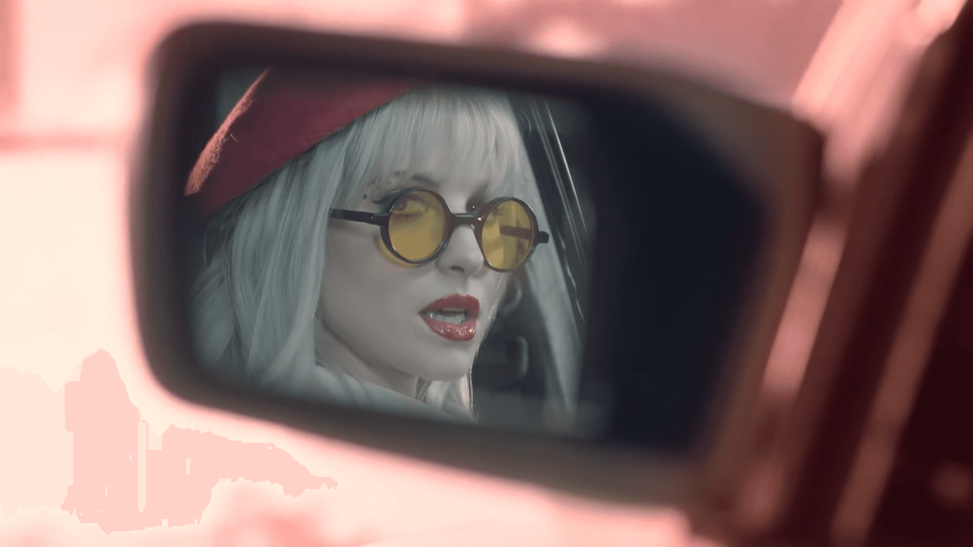 Snow-capped mountain peaks against a pastel sky