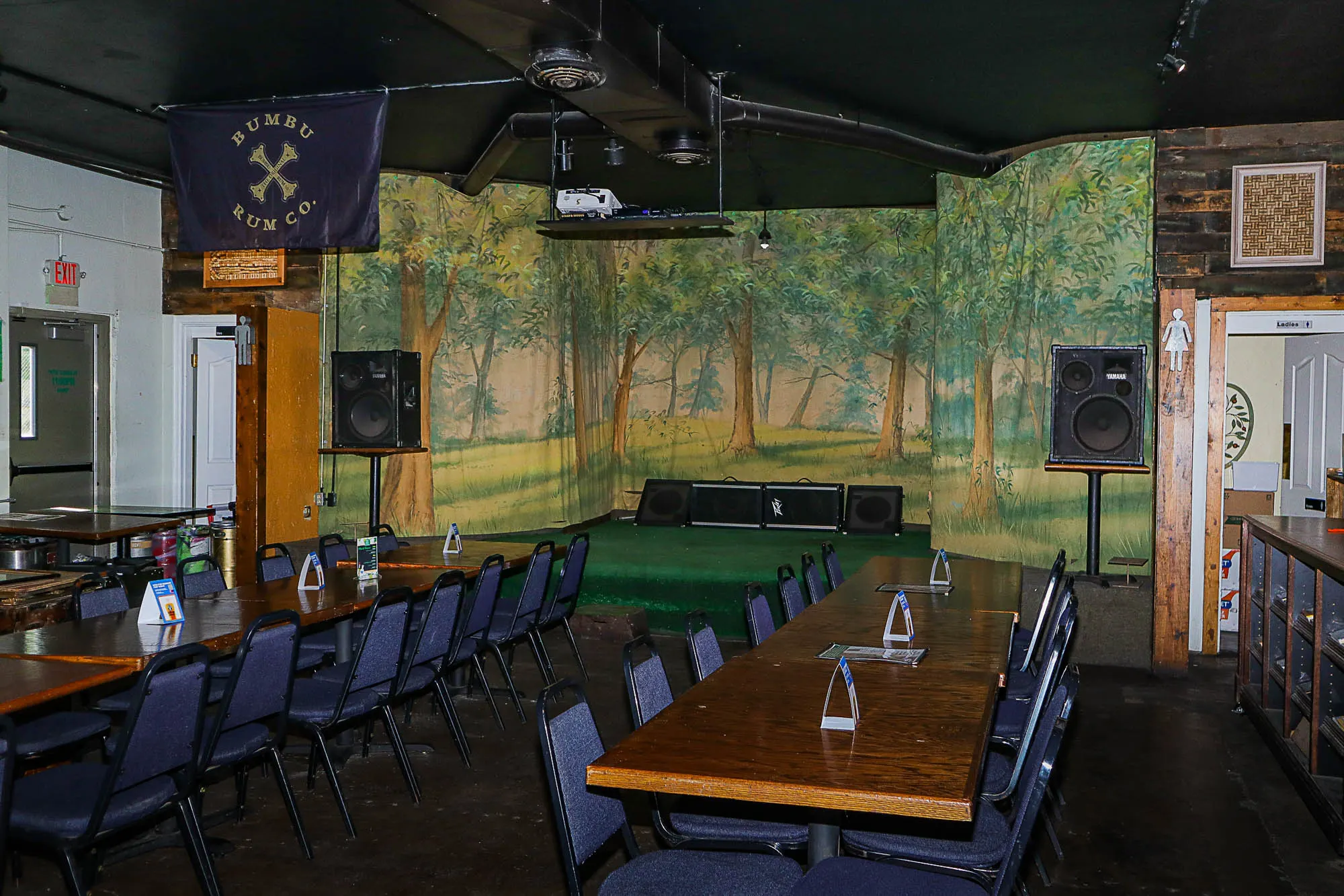 Seating, stage and sound system in the back of Hey Hey Bar & Grill