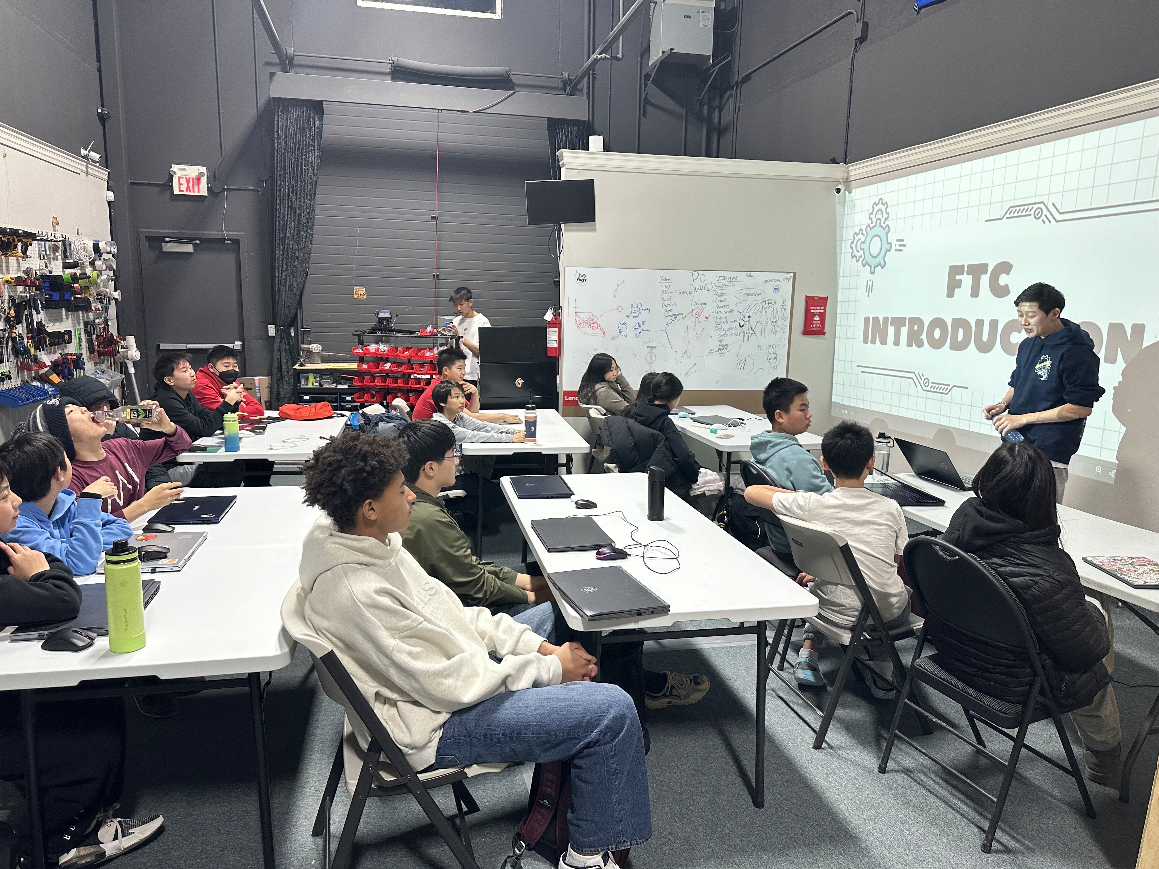 FRC 10015 Bubbles Team Captain speaks to the new FTC students during their first training session.