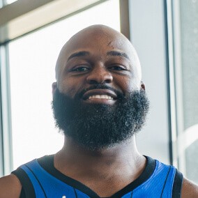 Possible member smiling and looking away from the camera.