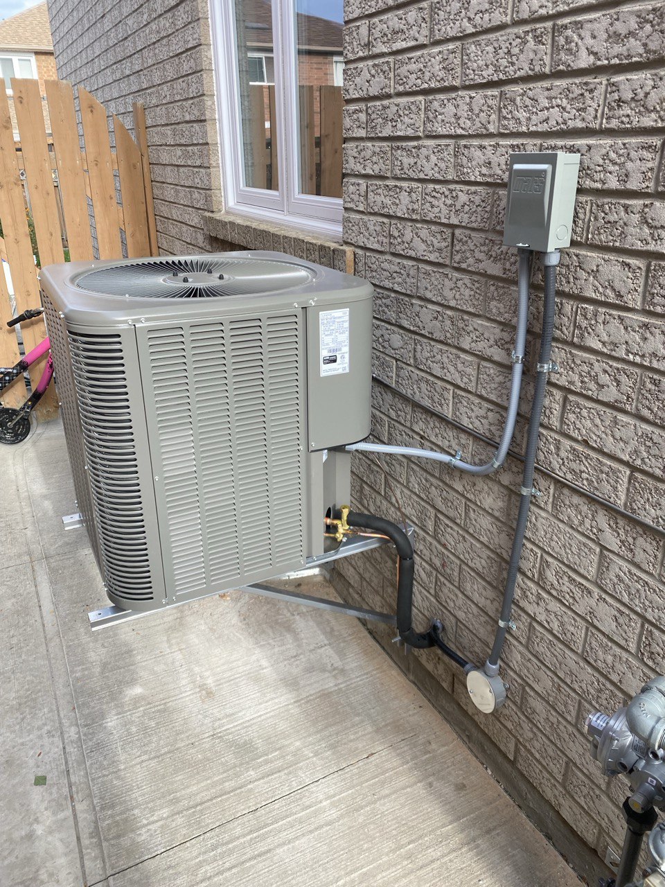 AC unit in a Oakville backyard during air conditioner repair service