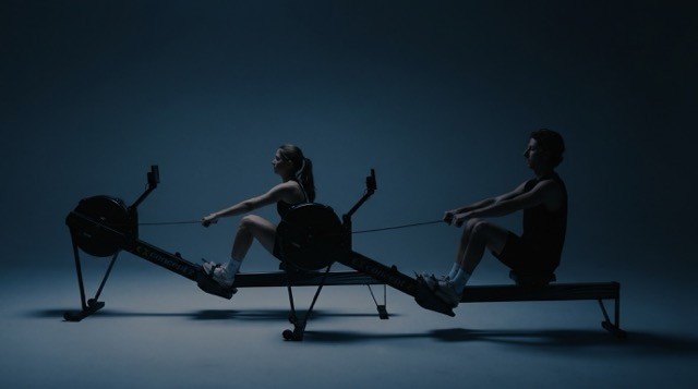 High school rowers erging together trying to improve their 2k results