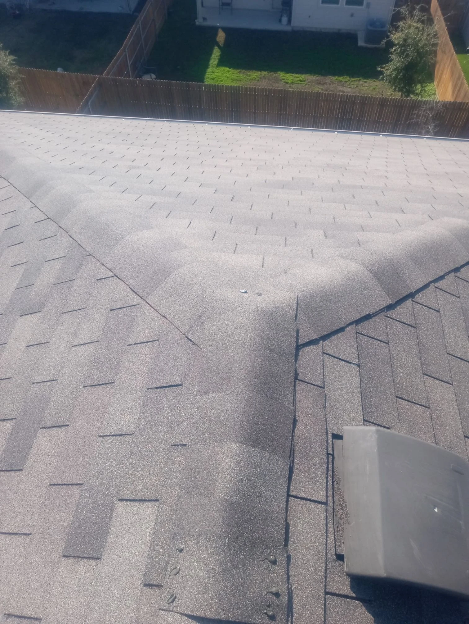 Finished repair: wind-damaged shingles restored in Austin, Texas.
