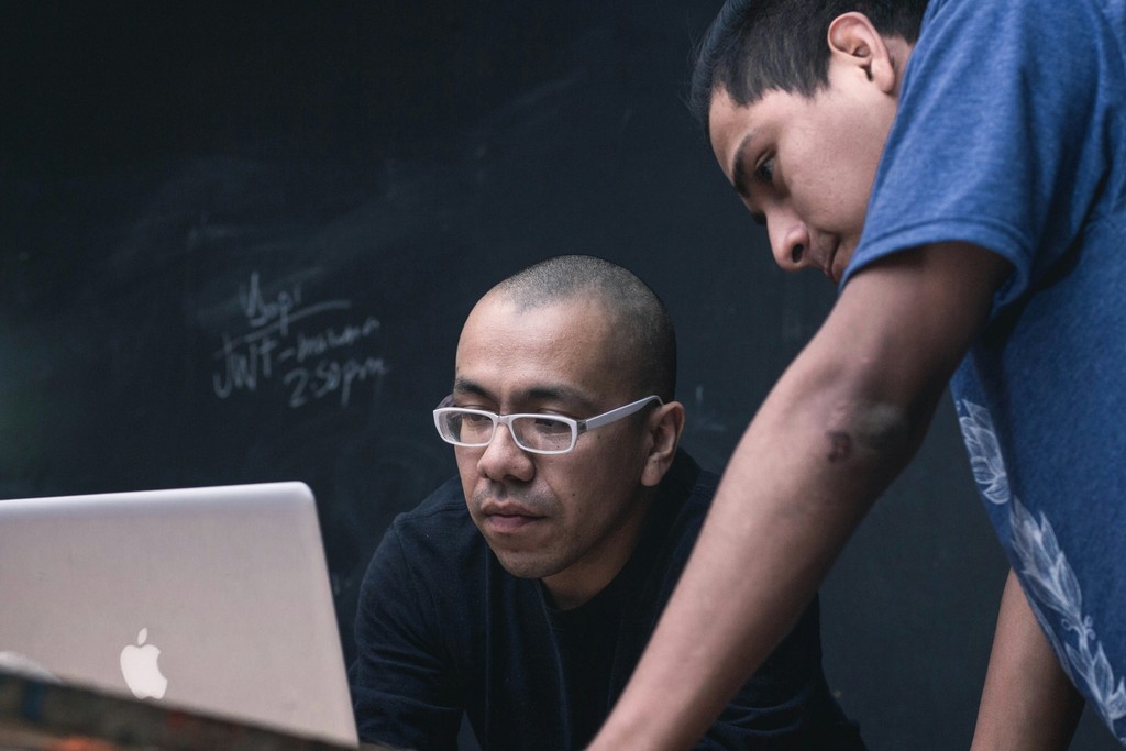 two people looking at laptop screen