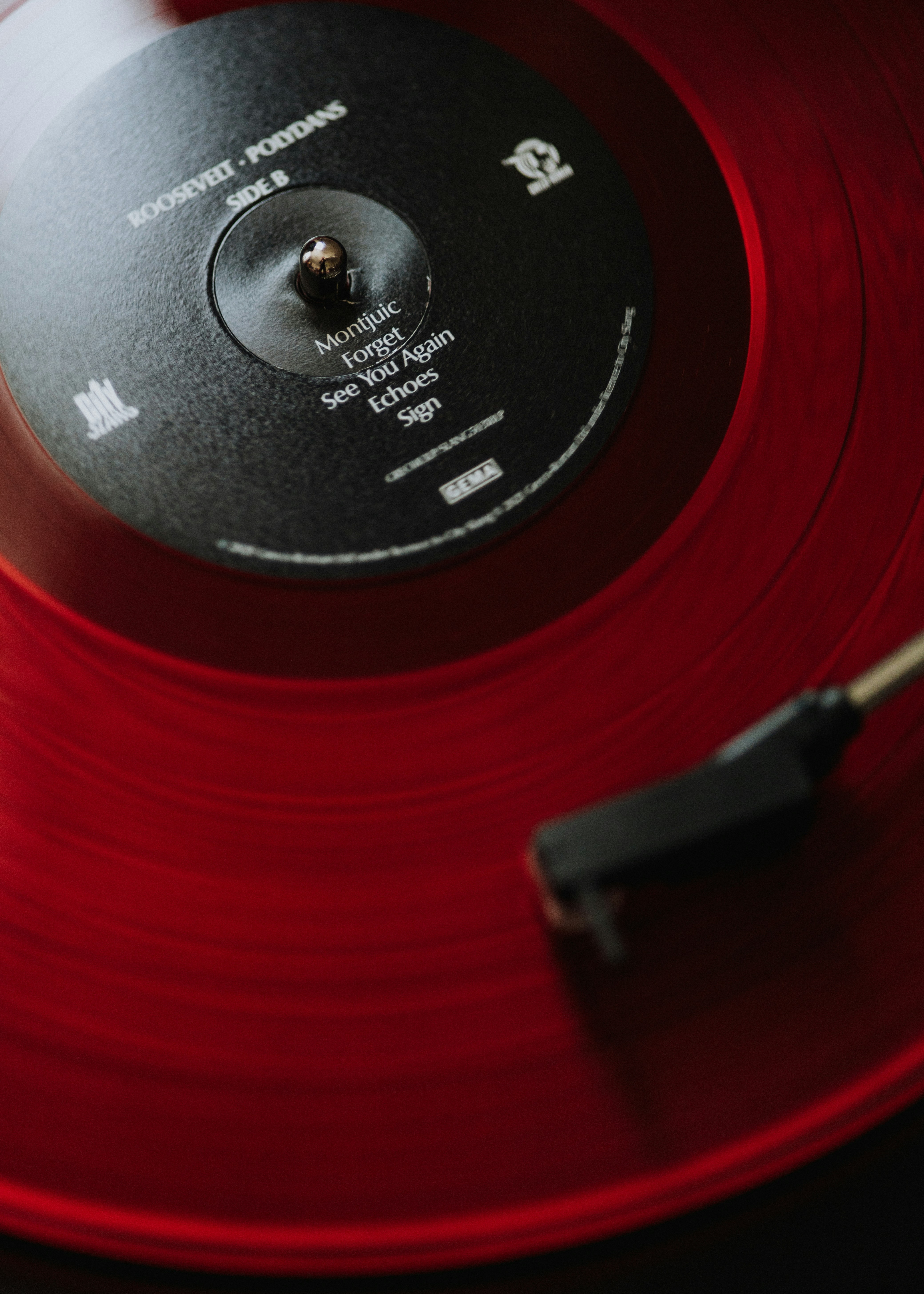 Red vinyl record spinning on a turntable, illustrating a listing going live on DWICE.