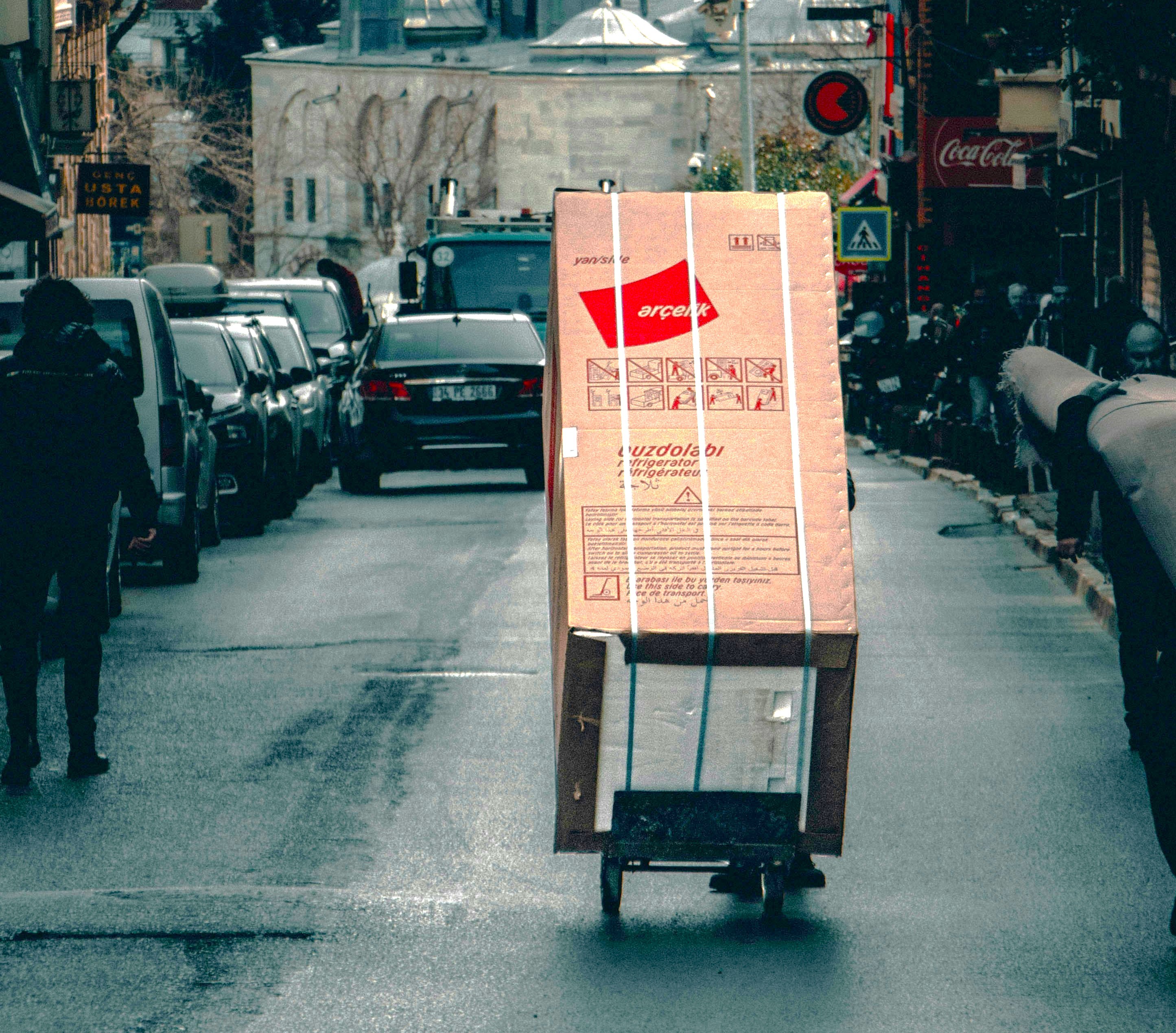 Delivery worker unloading an appliance package