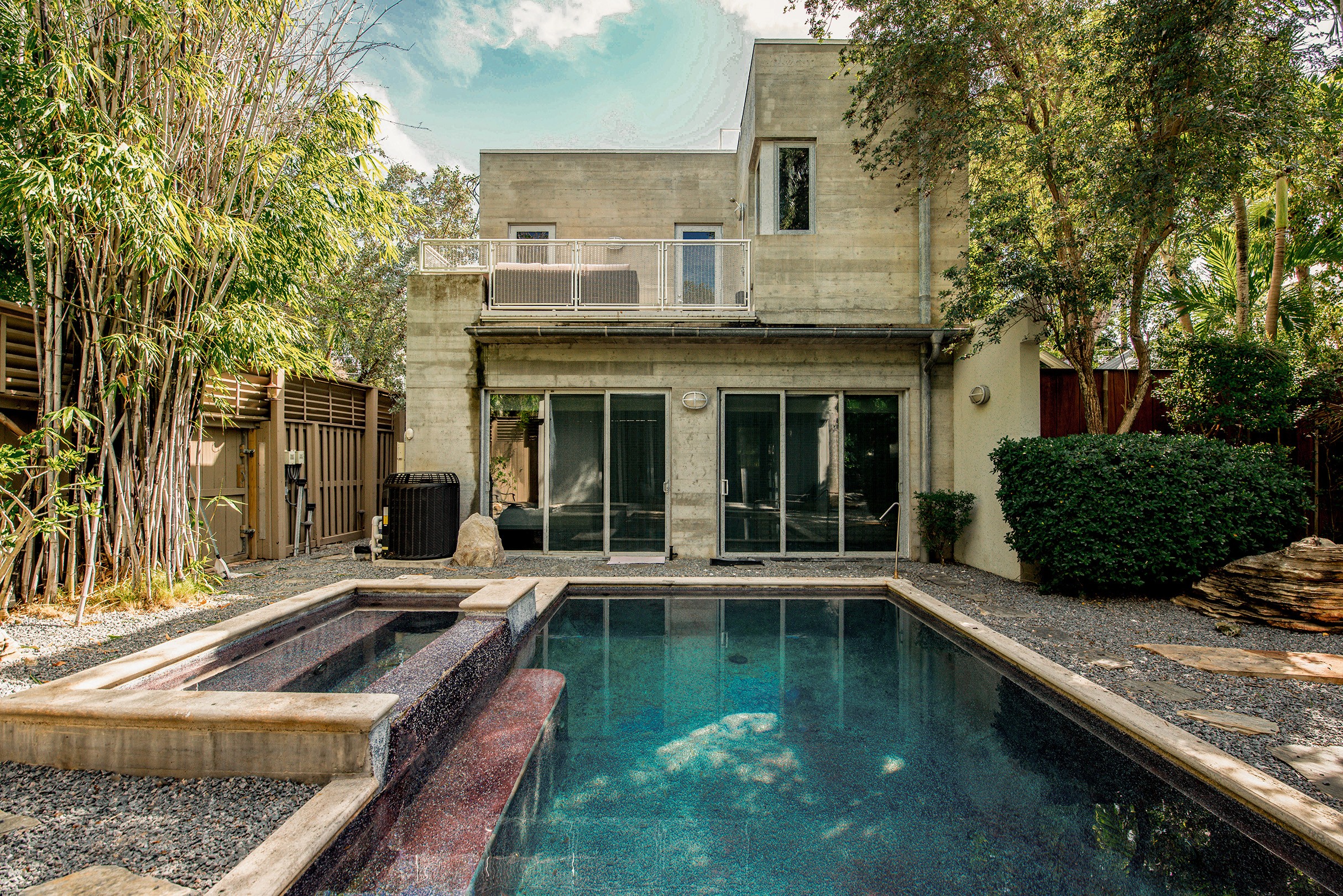 tranquil pool area surrounded by lush greenery—an exclusive Key West sanctuary for relaxation