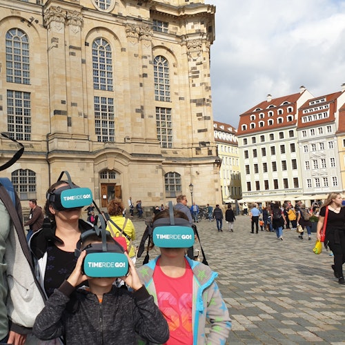 在德累斯顿圣母教堂前佩戴VR眼镜的一家人