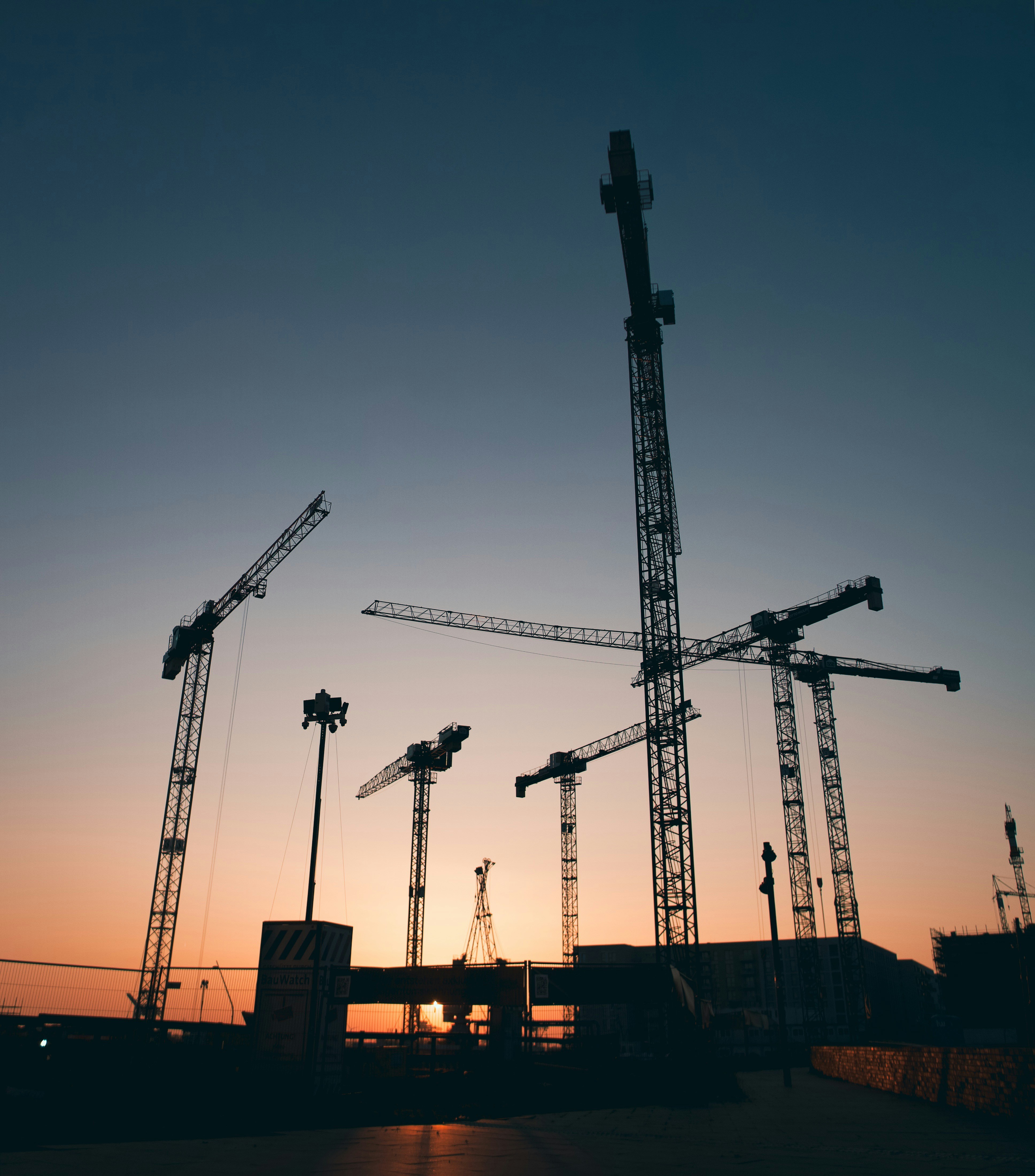 a group of cranes sitting next to each other