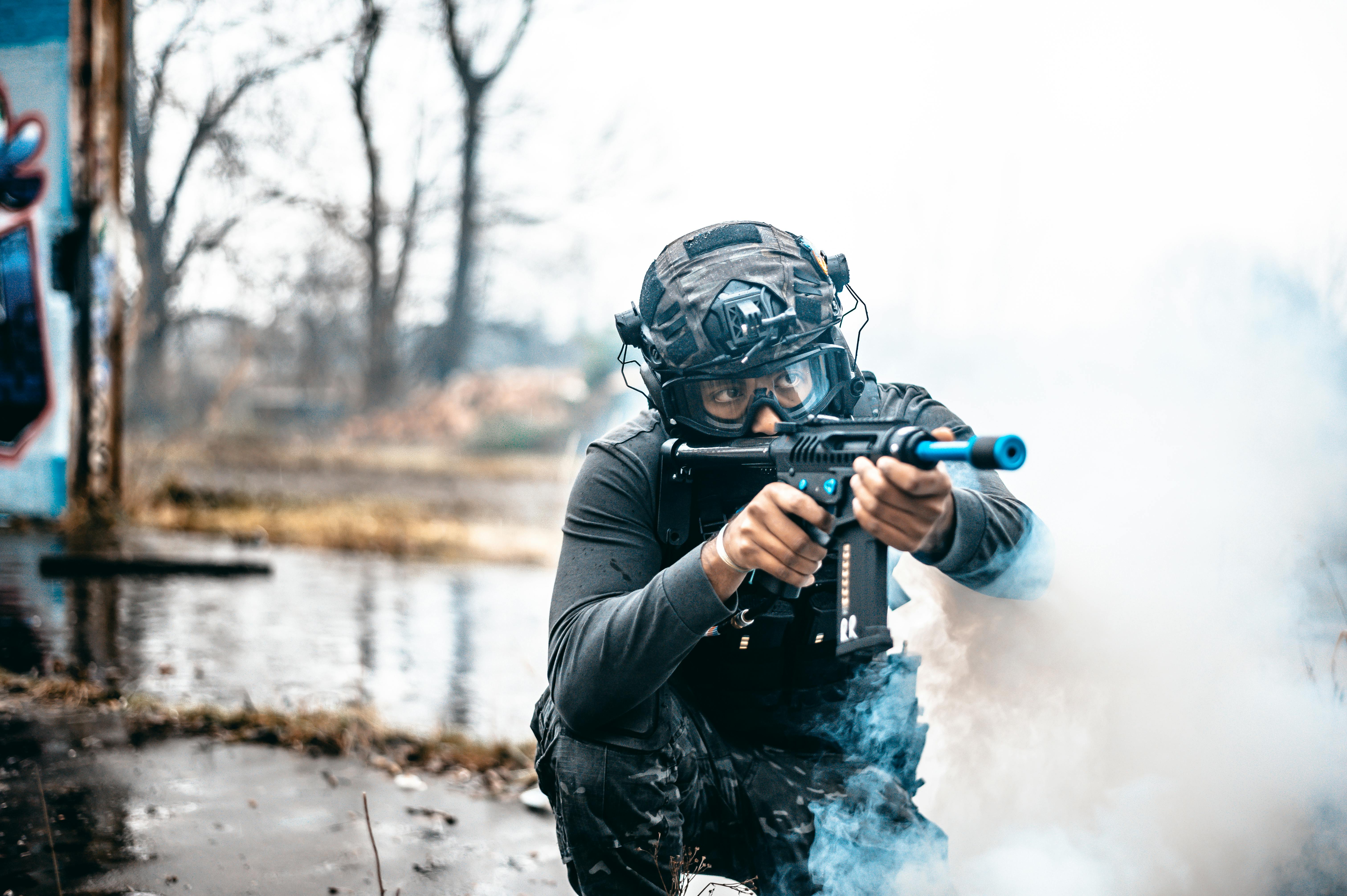 Close-up of lush, dark green leaves, some glossy and wet, against a muted background.