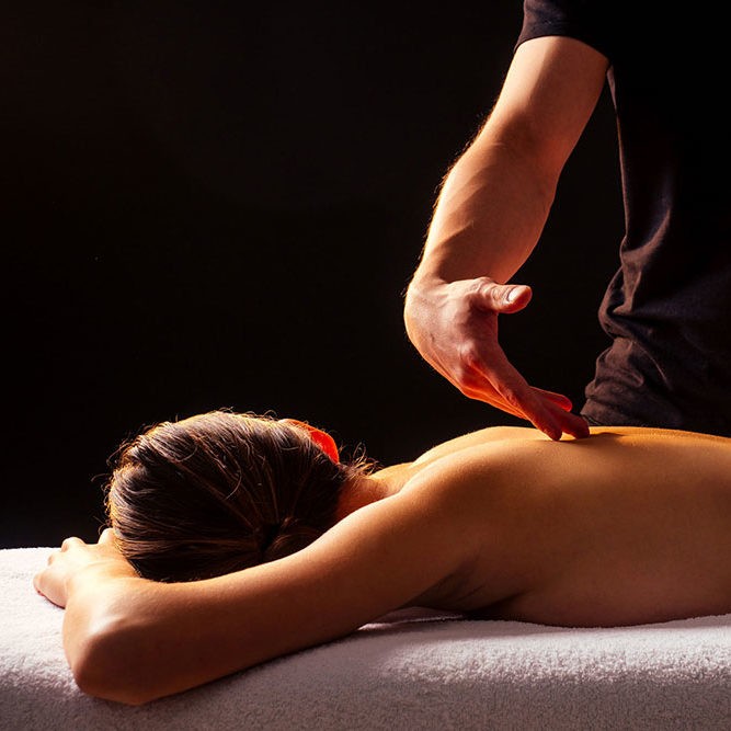 person holding white round ornament
