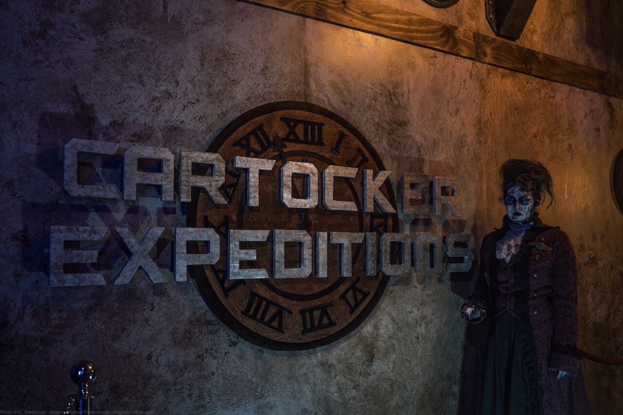 Cartocker Expeditions wall sign beside a costumed scare actor