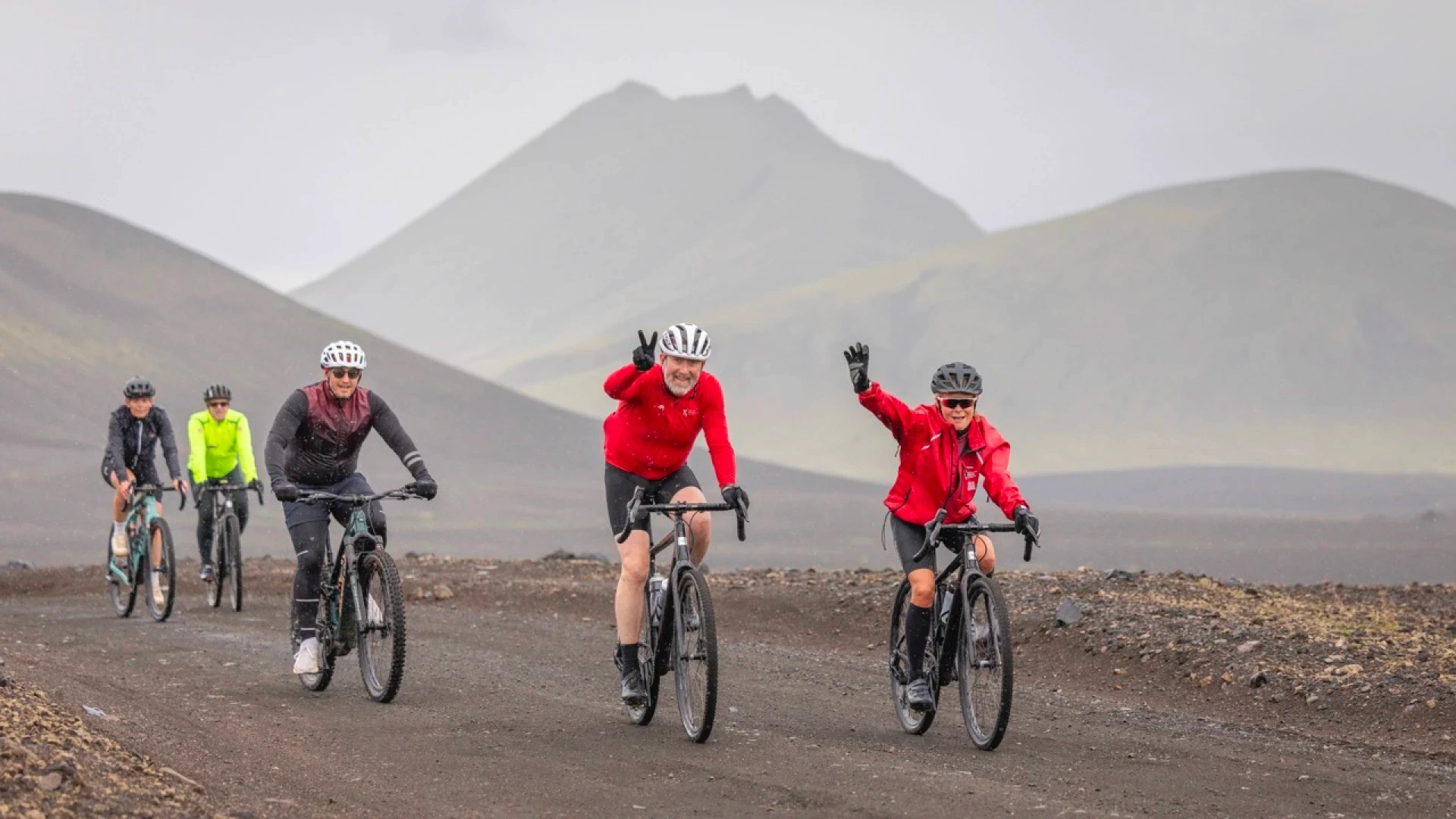 man raises hand in cycling trip