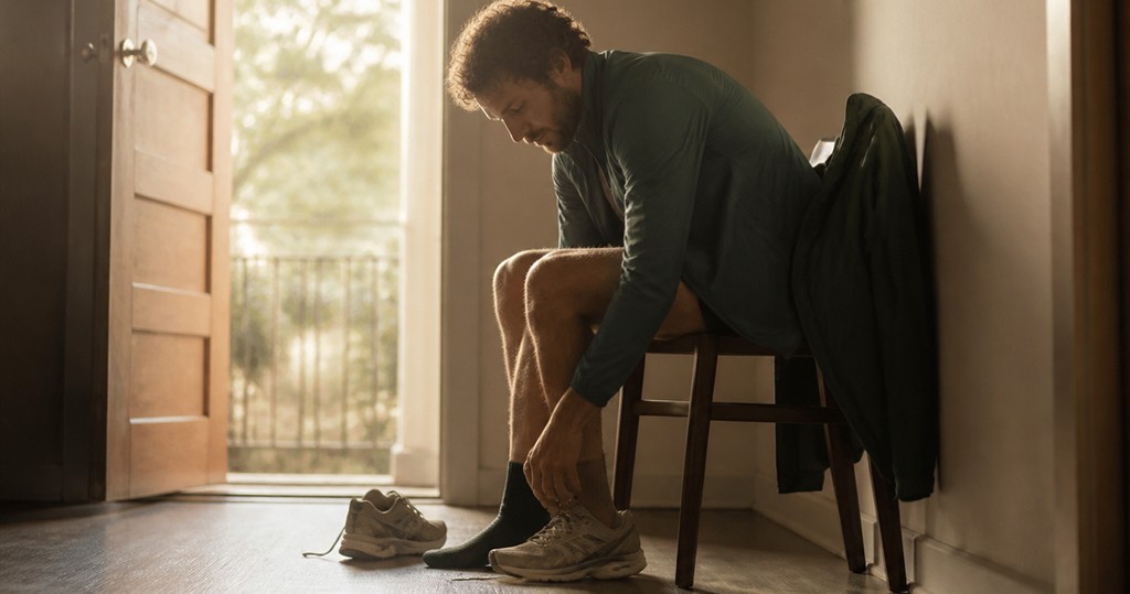 A pair of half laced running shoes by an open door at first light (AI-generated image)