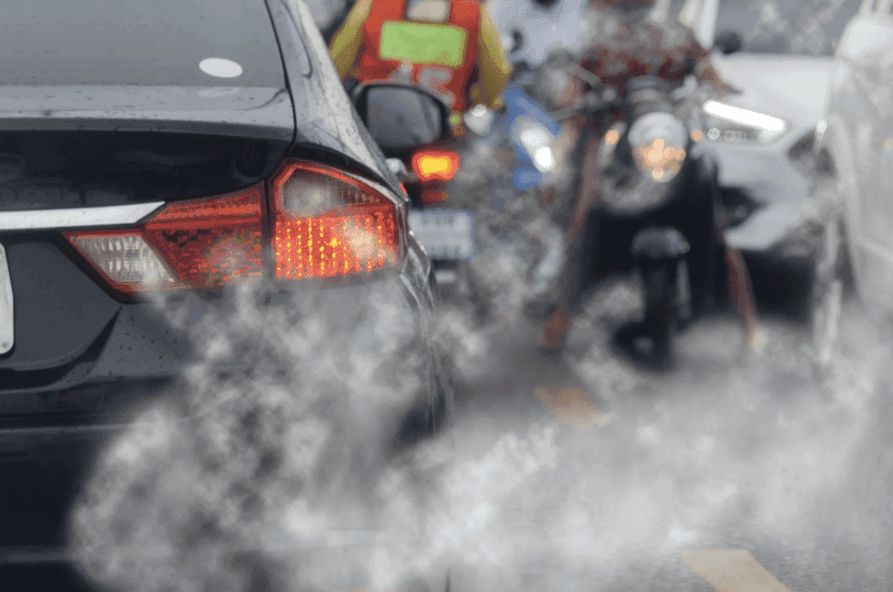 emissions from Cars and motorcycles sitting in traffic with a closeup shot to the back of the car