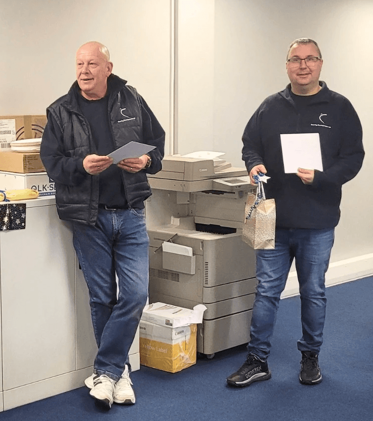 Directors Grant and Stuart receiving gifts on their 5th anniversary