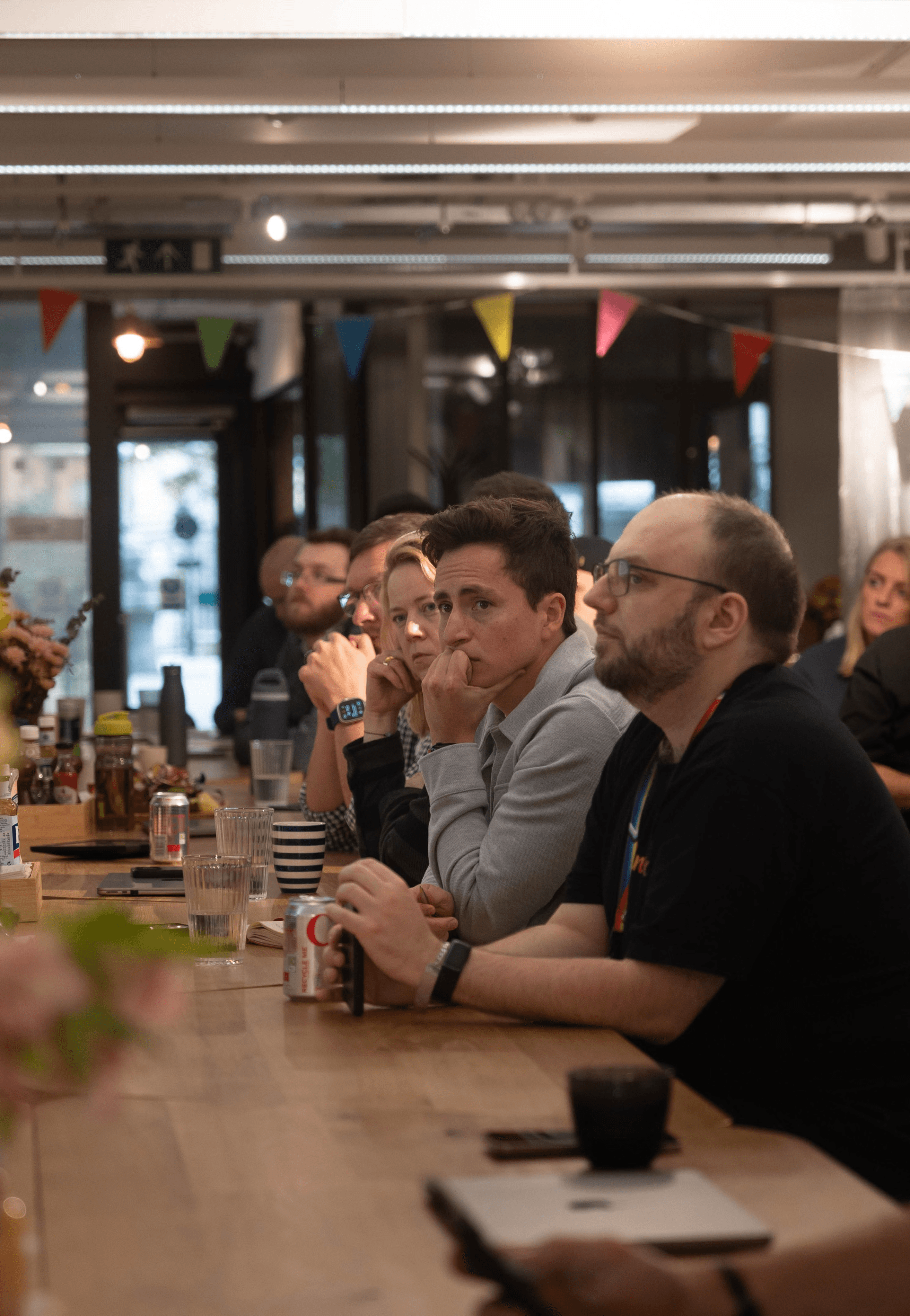 Team members listening at a Zorven community event