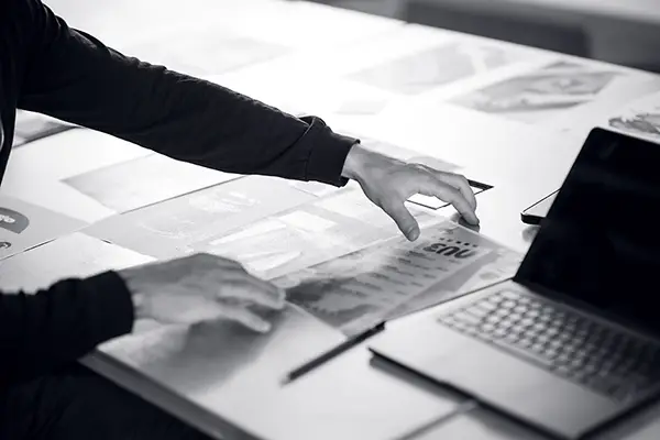 A working desk with desogns and computers