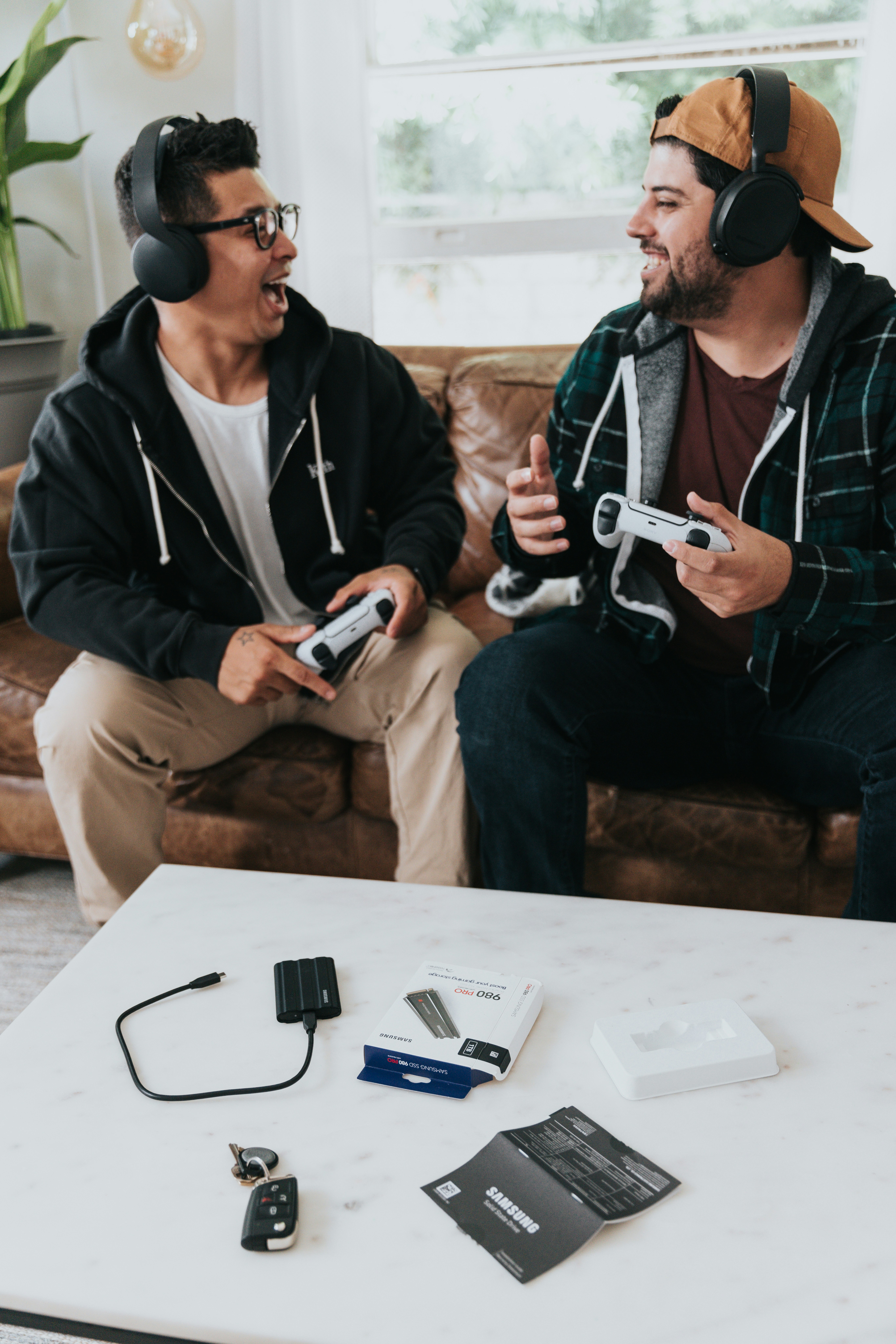 Friends using a rented VR headset and gaming console for a weekend hangout, highlighting flexible tech rentals with Oxigen.