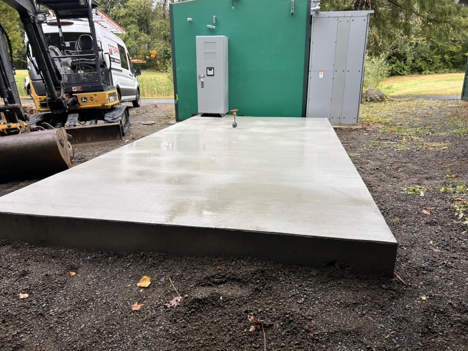 Concrete slab foundation poured for outdoor electrical cabinet in Oregon residential project