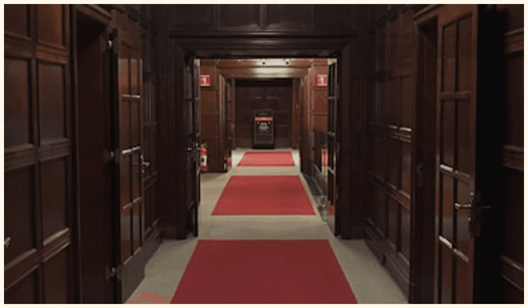 Wood-paneled hall, red carpet
