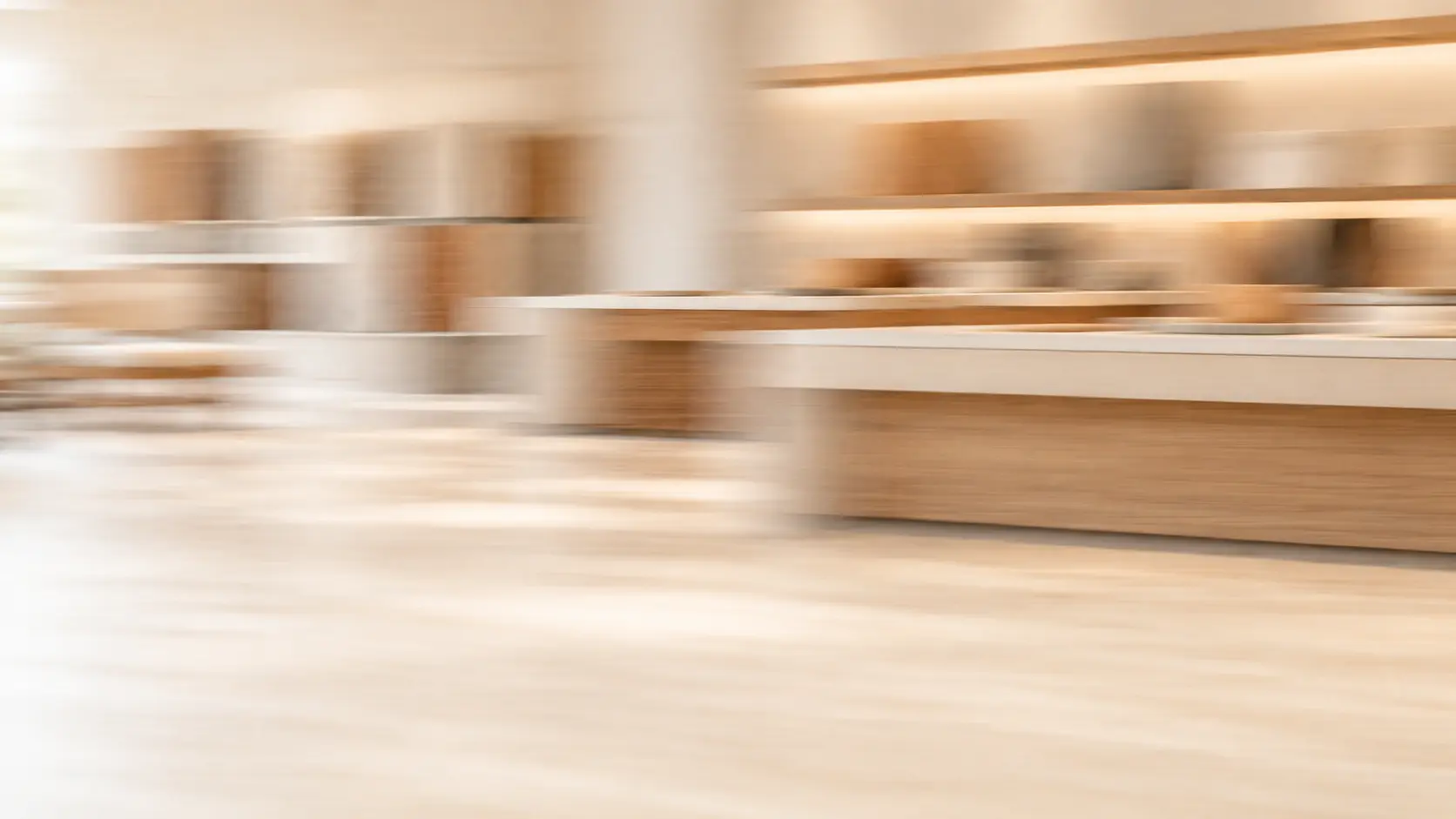 Daylit residents’ lounge, softly blurred by motion