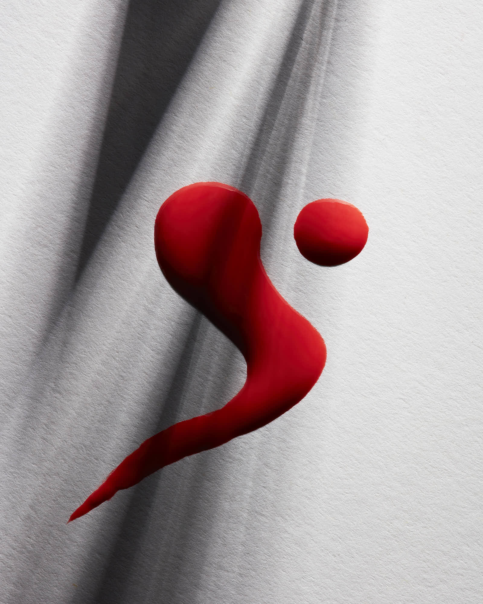 A stylized red paint with curvy dynamic design on a smooth gray background, featuring a dynamic, curvy design.