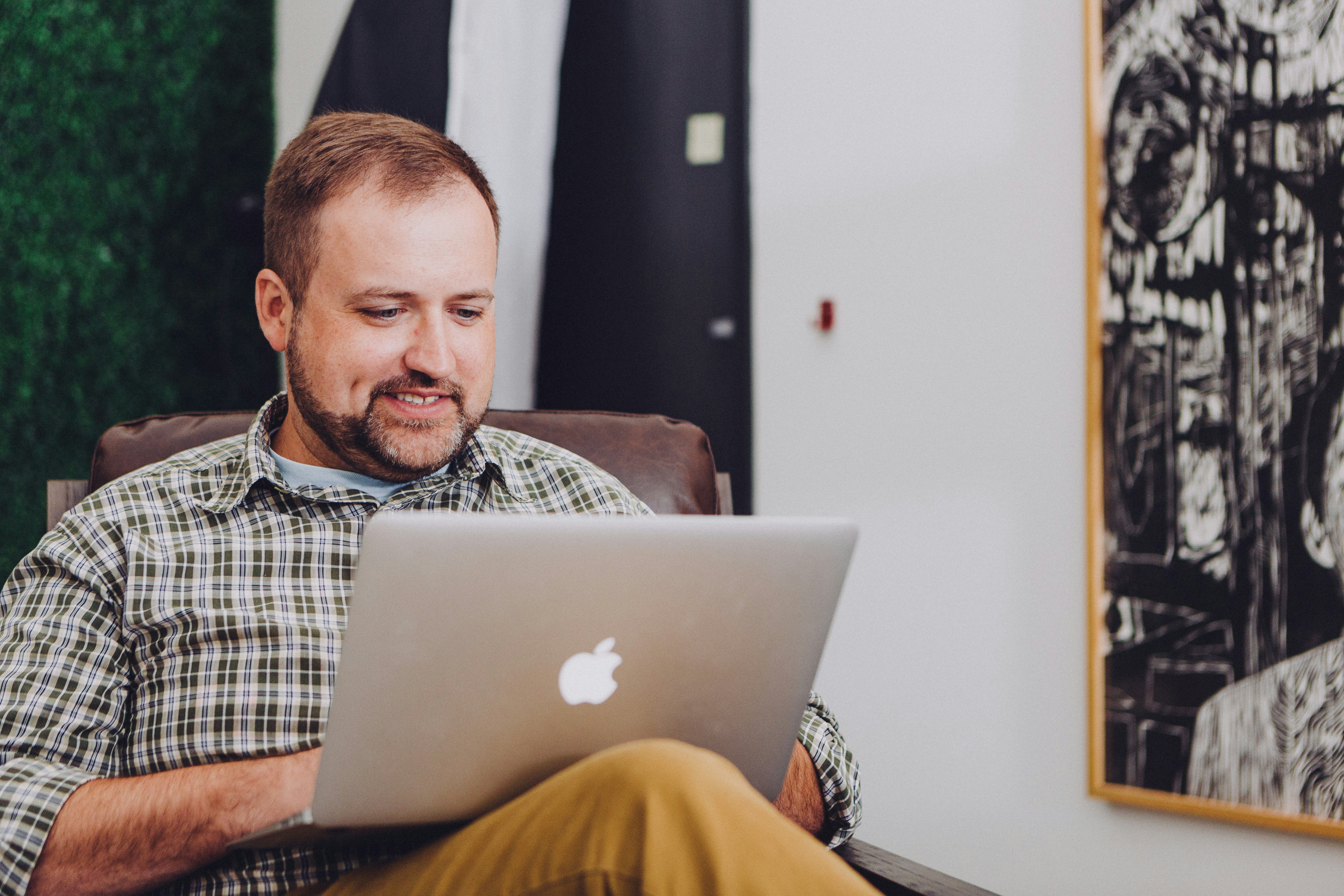 man with a smiley face using a laptop - Product Detail Page