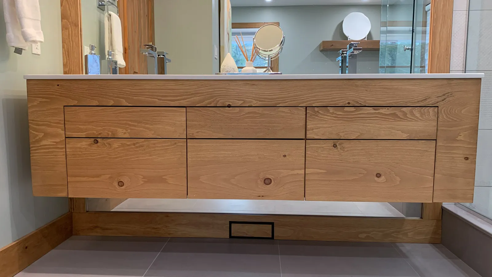 Custom built wood vanity in luxury primary bathroom with his and hers sinks.