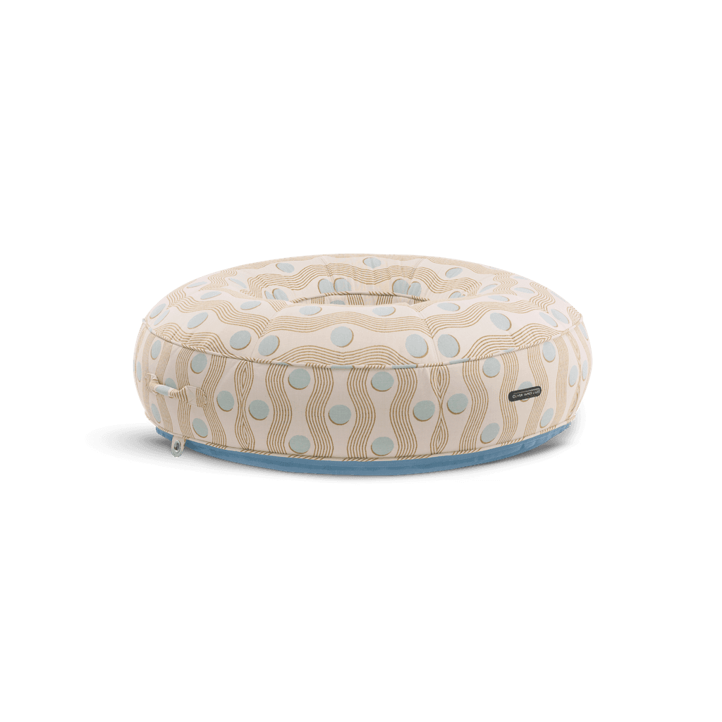 Ring-shaped luxury pool float in cream geometric-weave fabric with light blue accents